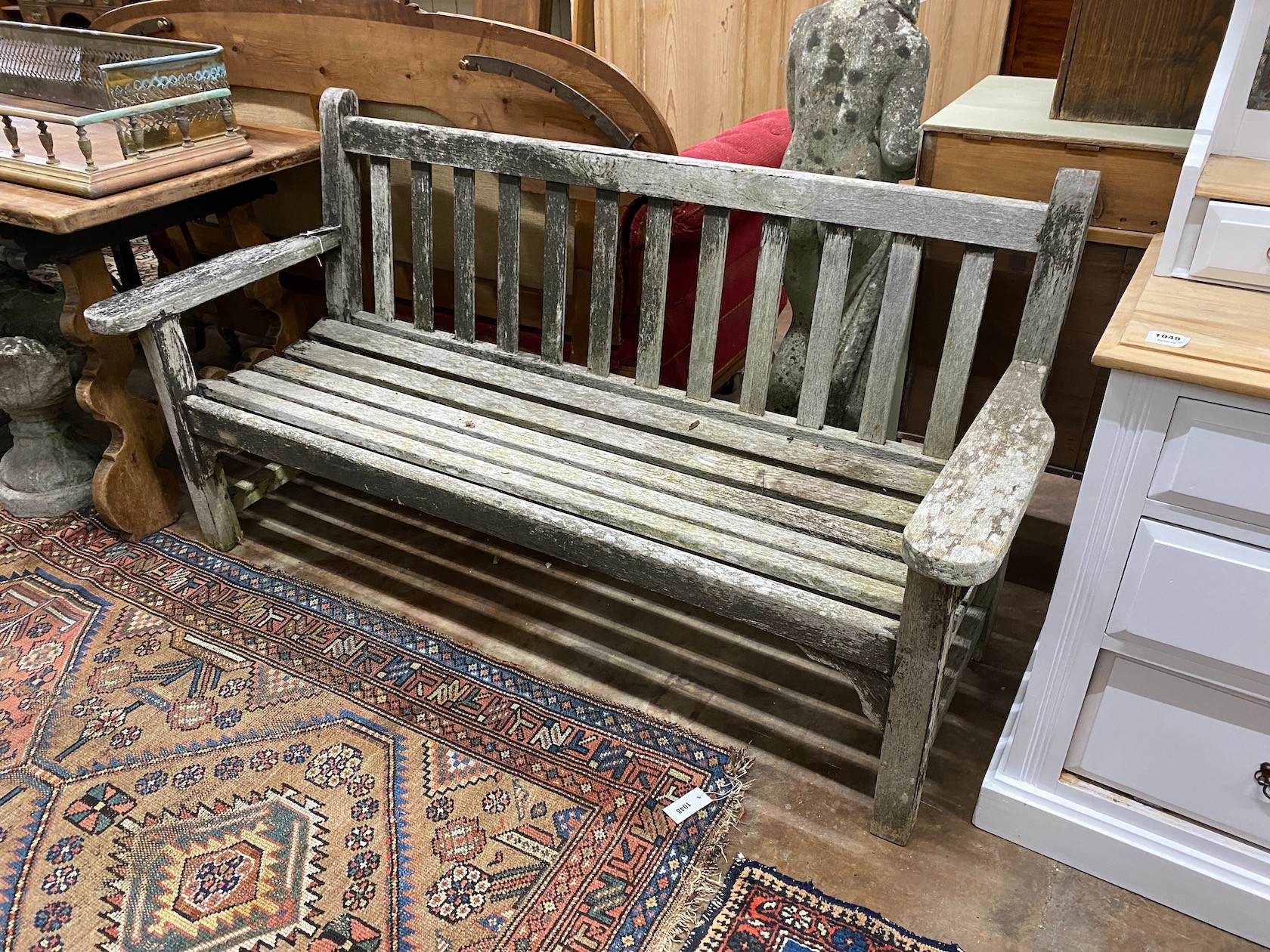A weathered teak garden bench, width 162cm